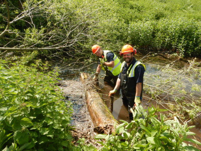 Mel SCDC staff placing flow deflector